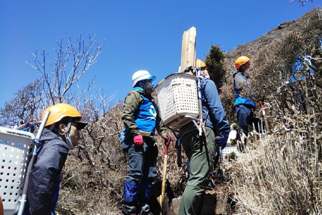 登山道整備班は、整備用の機材を背負って移動します